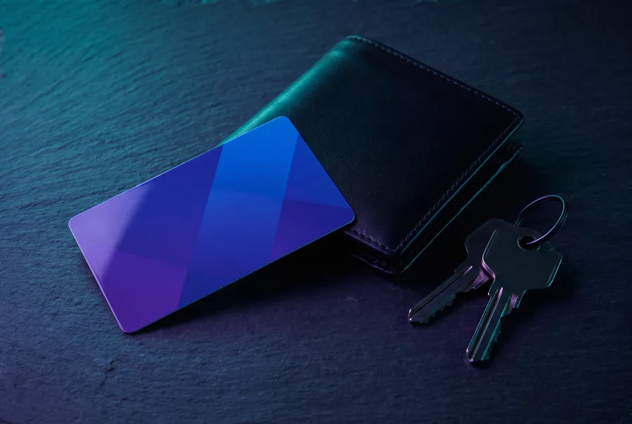 Plastic card, wallet and keys on dark slate