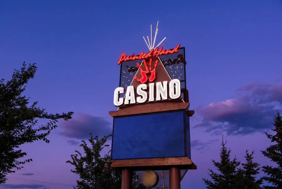 Painted Hand Casino roadside sign at dusk